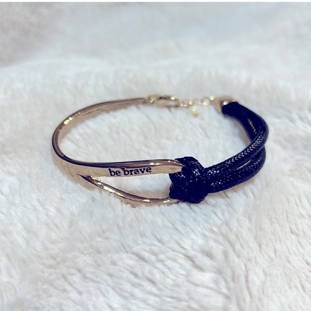 New in package Be Brave Gold Tone And Black
Knot Bracelet